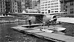 1930s 1939 WACO AIRPLANE ON FLOATS IN EAST RIVER AT WALL STREET DOWNTOWN SKYPORT NEW YORK CITY USA