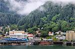 Juneau, State Capital, view from the sea, mist clears over downtown buildings, mountains, forest and float planes, Alaksa, United States of America, North America