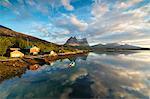 Pink clouds of midnight sun reflected in the clear water of blue sea, Anepollen Fjord, Nordland, Norway, Scandinavia, Europe