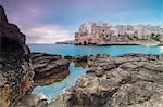 Turquoise sea at sunrise framed by the old town perched on the rocks, Polignano a Mare, Province of Bari, Apulia, Italy, Europe