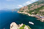 Tourist boat in the turquoise sea framed by limestone cliffs, Porto, Southern Corsica, France, Mediterranean, Europe