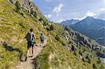 Hikers on path towards Rifugio Bignami, Malenco Valley, Valtellina, Lombardy, Italy, Europe