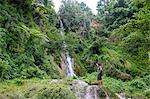 Man standing underneath the Mele Cascades, Efate, Vanuatu, Pacific