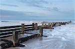 Incoming waves hitting a groyne at Walcott, Norfolk, England, United Kingdom, Europe