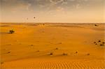 Hot air balloons over sand dunes at sunrise in the Dubai Desert, Dubai, United Arab Emirates, Middle East