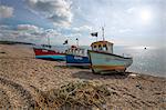 Three small fishing boats pulled up on shingle beach, Beer, Devon, England, United Kingdom, Europe