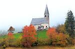 Church of Santa Magdalena in the autumn mist. Funes Valley, South Tyrol, Dolomites, Italy