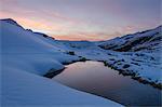 Sunset reflexes in a small water's pool at Fluela pass, Engadin, Switzerland