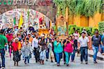 Group of people parading a relgious icon during the St Michael Archangel Festival procession in San Miguel de Allende, Mexico