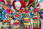 Group portrait of indigenous tribal dancers wearing colorful traditional costumes at the St Michael Archangel Festival parade in San Miguel de Allende, Mexico