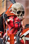 Close-up portrait of male, indigenous tribal dancer with face painted red and wearing skull mask at the St Michael Archangel Festival parade in San Miguel de Allende, Mexico