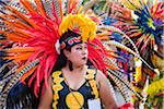 Close-up of a female, indigenous tribal dancer wearing feathered headdress in the St Michael Archangel Festival parade in San Miguel de Allende, Mexico