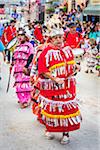 Close-up of female, indigenous tribal dancers in colorful costumes in the St Michael Archangel Festival parade in San Miguel de Allende, Mexico