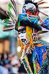 Close-up portrait of a young male, indigenous tribal dancer in colorful costume at the St Michael Archangel Festival parade in San Miguel de Allende, Mexico
