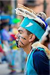 Close-up portrait of a young male, indigenous tribal dancer wearing turquoise headdress at the St Michael Archangel Festival parade in San Miguel de Allende, Mexico