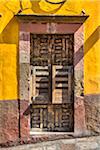 Close-up of a stone and wooden doorway on a traditional building in San Miguel de Allende, Mexico