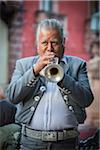 Close-up portrait of a Mariachi musician playing a trumpet outdoors in San Miguel de Allende, Mexico