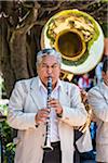 Close-up portrait of a Mariachi musician playing a clarinet outdoors in San Miguel de Allende, Mexico