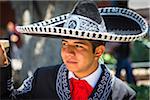 Close-up portrait of a male, Mexican dancer outdoors wearing traditional clothing in San Miguel de Allende, Mexico