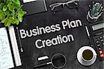 Business Plan Creation - Black Chalkboard with Hand Drawn Text and Stationery. Top View. 3d Rendering. Toned Image.