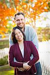 Outdoor Fall Portrait of Chinese and Caucasian Young Adult Couple.