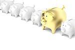 Row with piggy banks with one bigger and gold colored piggy bank
