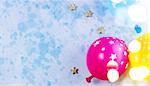 Bright colorful carnival or party scene of balloons on blue table. Flat lay style, birthday or party greeting card with copy space and bokeh lights