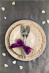 Valentines day table. Plate with two forks and hearts. Valentine's day dinner.St. Valentine table setting