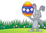 Bunny holding big Easter egg topic 3 - eps10 vector illustration.