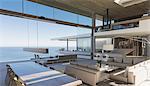 Modern, luxury home showcase interior living room and dining room with ocean view