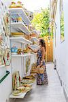 Ravello, Amalfi coast, Salerno, Campania, Italy. A tourist is having a look at a pottery store in Ravello (MR)