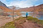 Tourist staring at Lake Devero, Alpe Veglia and Alpe Devero Natural Park, Baceno, Verbano Cusio Ossola province, Piedmont, Italy