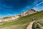 Trekker walking towards Gran Sasso, Campo Imperatore, L'Aquila province, Abruzzo, Italy, Europe