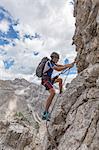 Climber on the via ferrata Cengia Gabriella, Popera group, Giralba, Sexten Dolomites, Belluno, Veneto, Italy