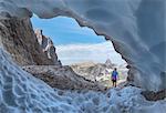 Italy, South Tyrol, Hocpustertal, Sexten. Snow cave in the summer season along the Alpinisteig / Strada degli alpini via ferrata, Sexten Dolomites