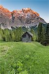 La Valle / Wengen, Alta Badia, Bolzano province, South Tyrol, Italy. Sunset on the pastures of Pra de Rit with the peak Cima Dieci / Zehnerspitze