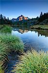 Rocky peak of Sasso Moro reflected in Lake Mufulè at dawn Malenco Valley Lombardy province of Sondrio Valtellina Italy Europe