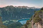 Overview of rocky peaks and lake at dawn, San Romerio Alp, Brusio, Canton of Graubünden, Poschiavo valley, Switzerland