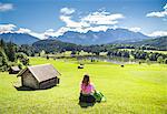 A girl in typical dress looks at the Geroldsee. Gerold, Garmisch Partenkirchen, Bayern, Germany