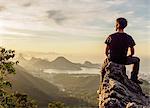 Hiker enjoying the view of Rio de Janeiro from Pedra da Proa, Tijuca Forest National Park, State of Rio de Janeiro, Brazil, South America