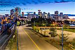 View of city skyline and Vancouver Lookout Tower at dusk from Portside, Vancouver, British Columbia, Canada, North America