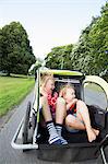 Sisters in bicycle trailer in Smaland, Sweden