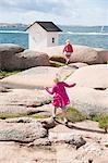 Girls playing on rocks at Stangehuvuds Nature Reserve in Sweden