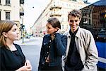 Young people standing in street talking