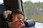 Girl sitting in train and using smart phone