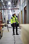 Woman in protective clothing standing and looking away