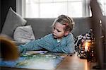 Girl playing board game on coffee table