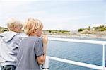 Two boys looking at lake in the Stockholm archipelago