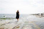Rear view of mature woman wading in sea in the Stockholm archipelago
