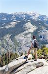 Boy looking at view with Sentinel Dome and Yosemite Falls